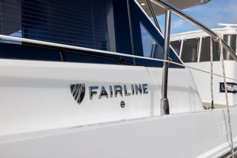 Slide: The Image of 2025 Fairline Squadron 50 yacht, sleek design with logo detail. - 79