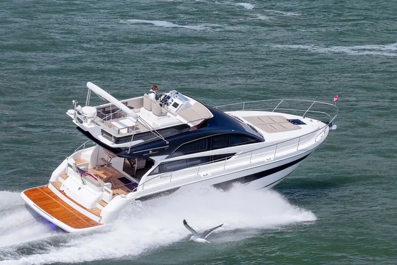 Slide: The Image of 2025 Fairline Squadron 50 yacht cruising on open water, showcasing luxury and performance. - 14
