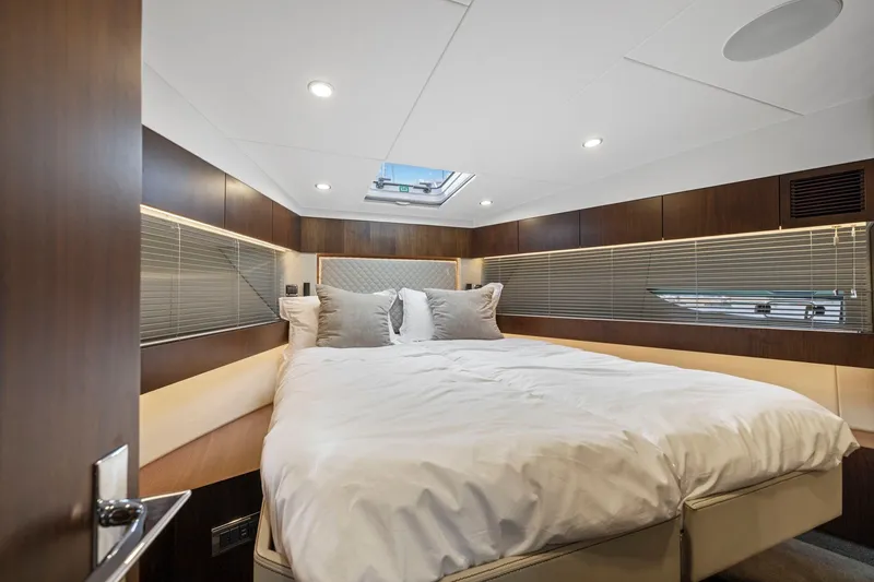 Slide: The Image of Luxurious cabin interior of 2025 Fairline Squadron 50 yacht with modern design and cozy bedding. - 23