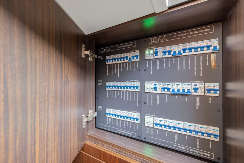 Slide: The Image of Electrical distribution panel inside 2025 Fairline Squadron 50 yacht, showcasing circuit breakers. - 99
