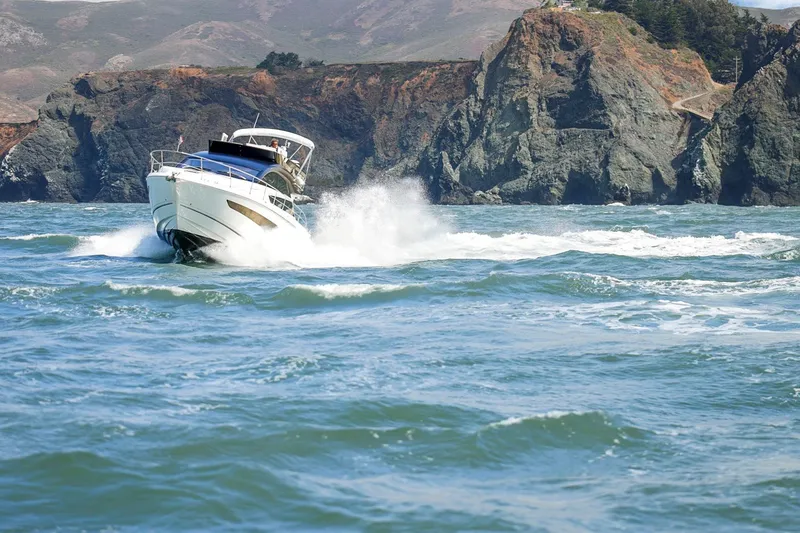 Slide: The Image of 2025 Fairline Squadron 50 yacht cruising near rocky coastline. - 22