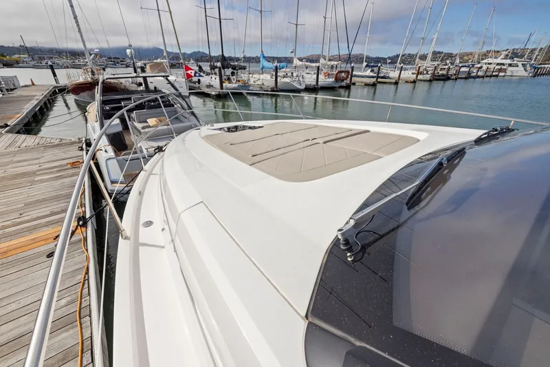 Slide: The Image of 2025 Fairline Squadron 50 yacht docked at marina with sailboats in background. - 89