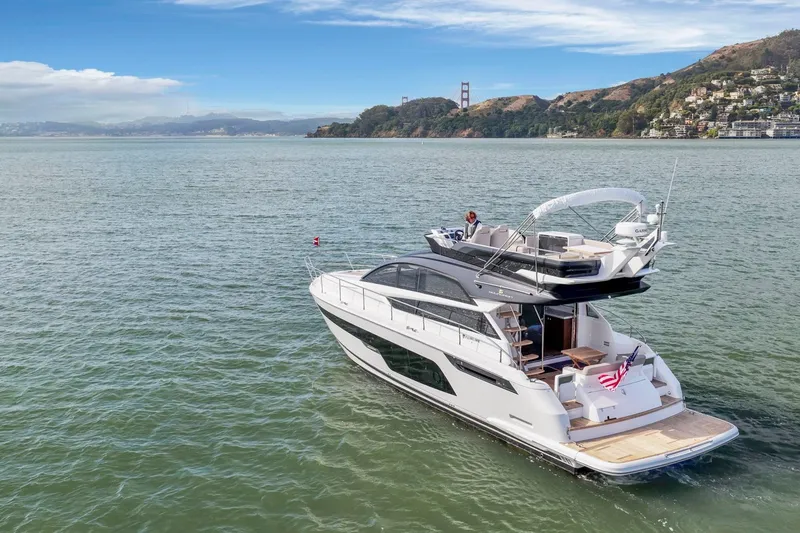 Slide: The Image of Luxury Fairline Squadron 50 yacht cruising near scenic coastline, 2025 model. - 46