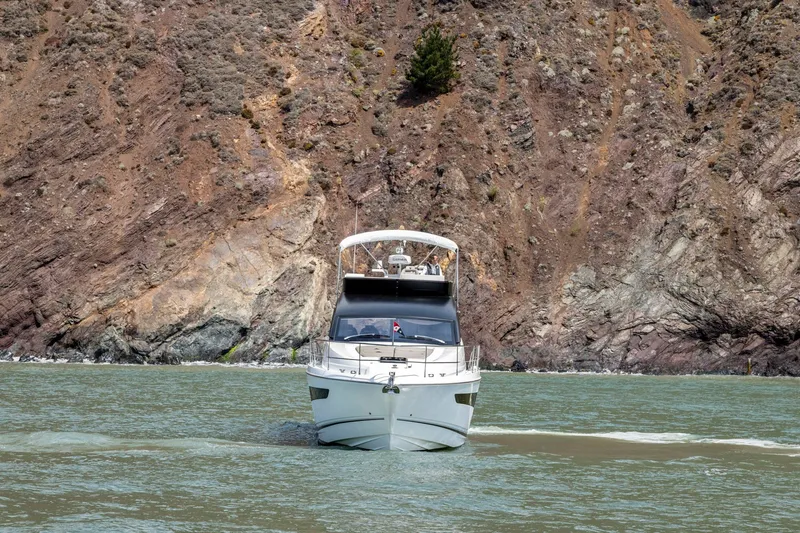 Slide: The Image of 2025 Fairline Squadron 50 yacht cruising near rocky coastline. - 39