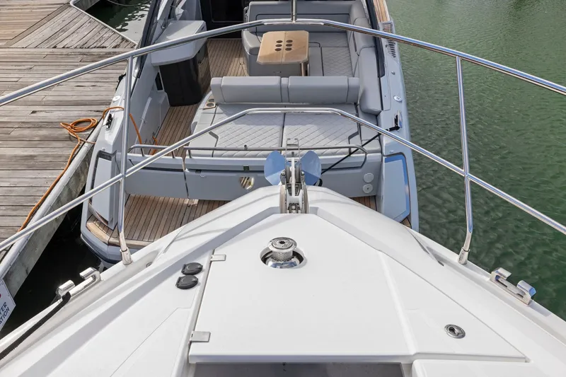 Slide: The Image of 2025 Fairline Squadron 50 yacht docked, showcasing spacious deck and seating area. - 87