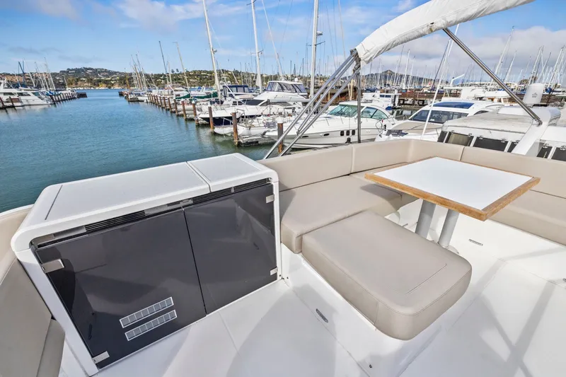 Slide: The Image of Luxury seating area on 2025 Fairline Squadron 50 yacht, docked in a marina. - 49