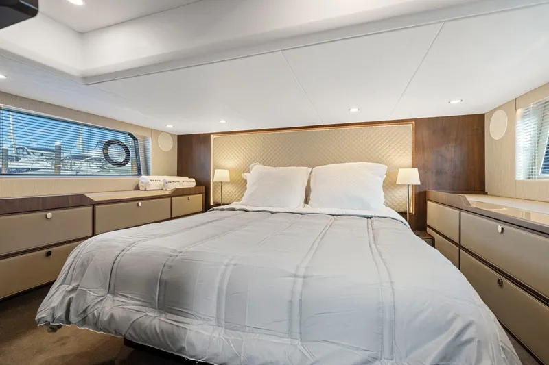 Slide: The Image of Luxurious bedroom interior of 2025 Fairline Squadron 50 yacht, featuring elegant design and cozy bedding. - 30
