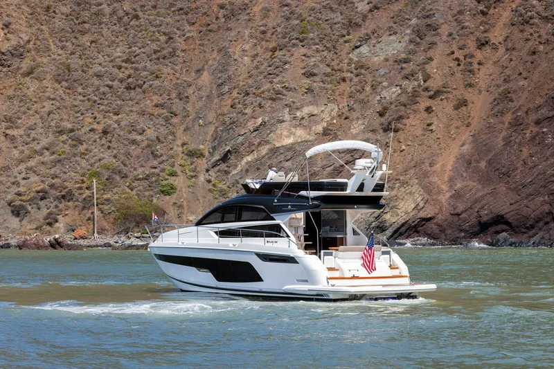 Slide: The Image of 2025 Fairline Squadron 50 yacht cruising near rocky coastline. - 43