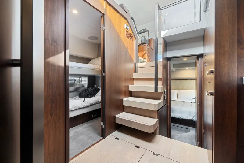 Slide: The Image of Interior of 2025 Fairline Squadron 50 yacht with modern wood finishes and cozy sleeping quarters. - 71