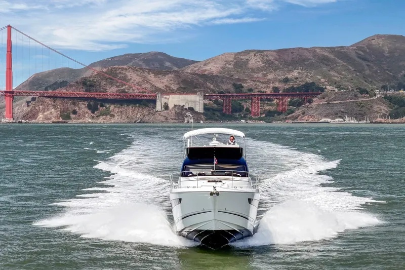 Slide: The Image of 2025 Fairline Squadron 50 yacht cruising near iconic red bridge and scenic hills. - 17