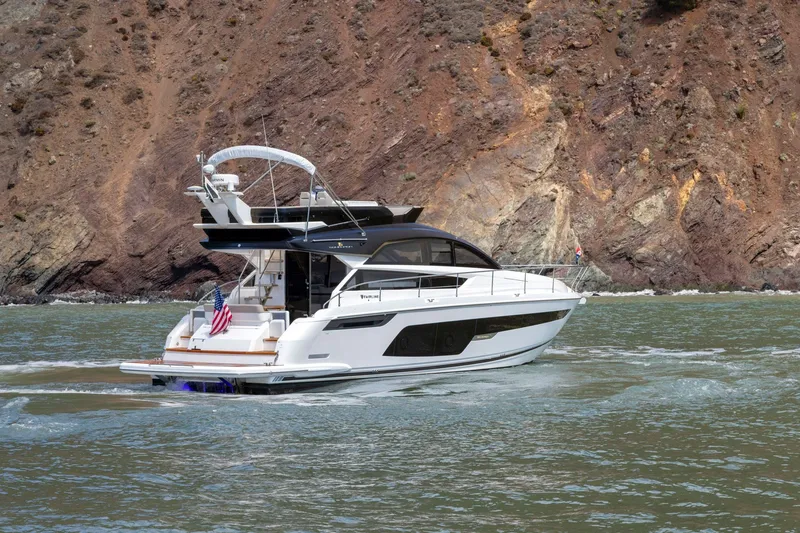 Slide: The Image of 2025 Fairline Squadron 50 yacht cruising near rocky coastline. - 41