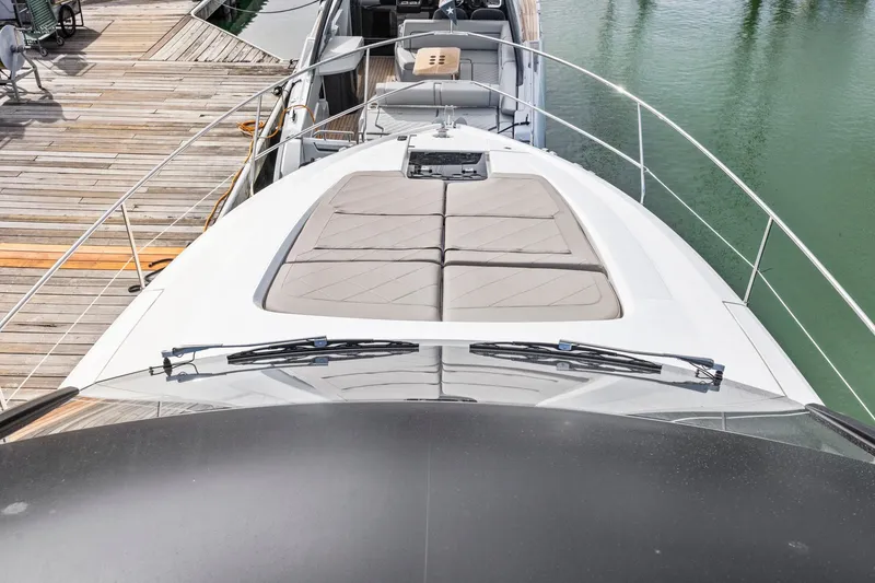 Slide: The Image of 2025 Fairline Squadron 50 yacht with spacious deck and luxurious seating at the marina. - 96