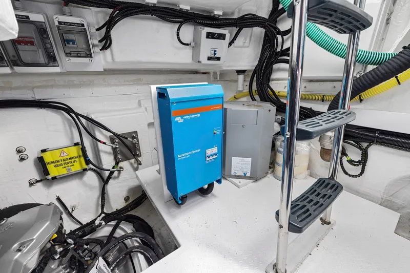 Slide: The Image of Engine room of 2025 Fairline Squadron 50 yacht with electrical equipment and ladder. - 105