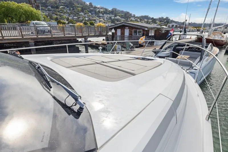 Slide: The Image of 2025 Fairline Squadron 50 yacht docked at a scenic marina with hillside views. - 86
