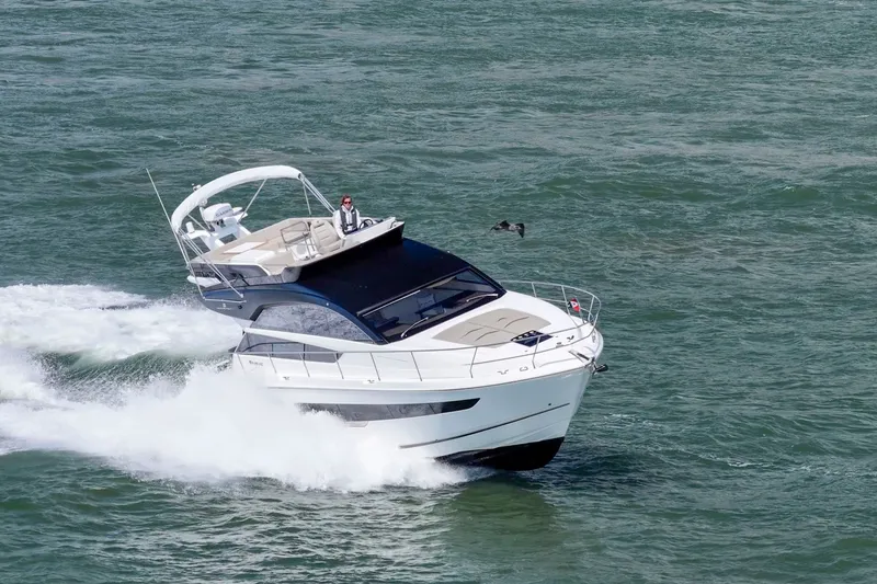 Slide: The Image of 2025 Fairline Squadron 50 yacht cruising on open water. - 15