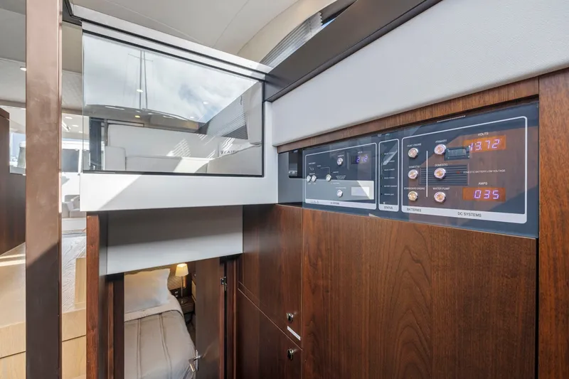 Slide: The Image of 2025 Fairline Squadron 50 yacht interior with control panel and cabin view. - 98