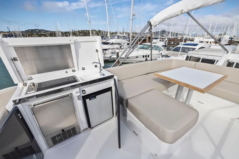 Slide: The Image of Luxurious 2025 Fairline Squadron 50 yacht deck with seating and outdoor kitchen. - 50