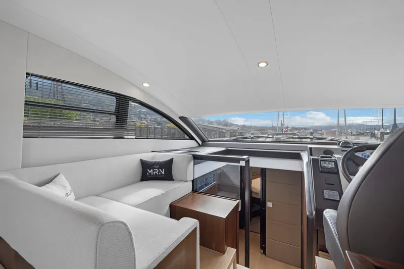 Slide: The Image of Luxurious interior of 2025 Fairline Squadron 50 yacht with modern seating and panoramic windows. - 56