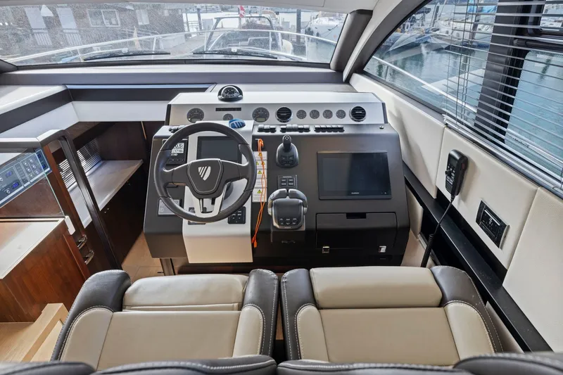 Slide: The Image of Modern helm station of 2025 Fairline Squadron 50 yacht with advanced navigation controls. - 58