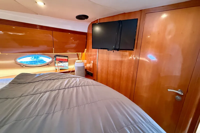 Slide: The Image of Luxurious cabin interior of 2006 Azimut Atlantis 47 yacht with TV and porthole. - 28