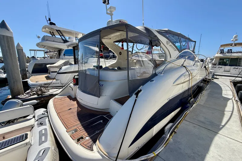 Slide: The Image of 2006 Azimut Atlantis 47 yacht docked at marina under clear blue sky. - 4