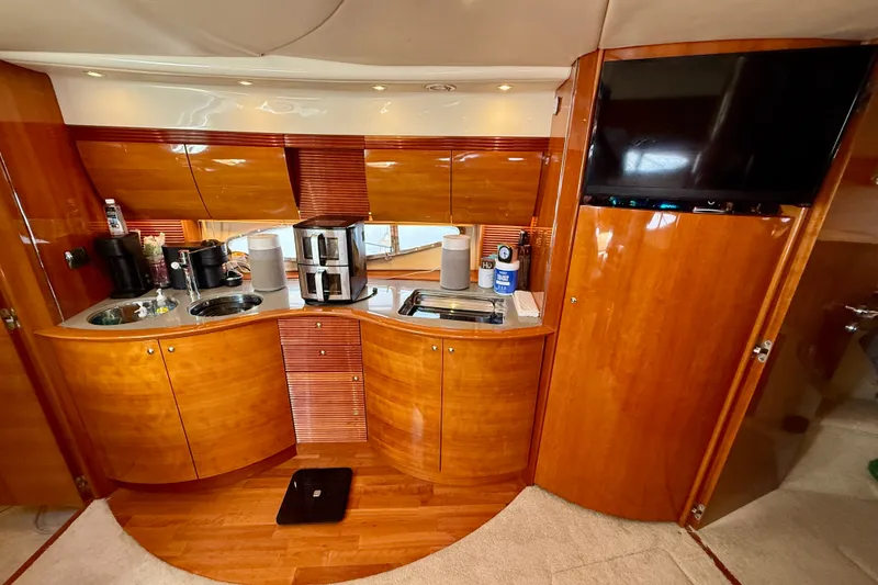Slide: The Image of Luxurious 2006 Azimut Atlantis 47 yacht interior with sleek wooden cabinetry and modern amenities. - 22