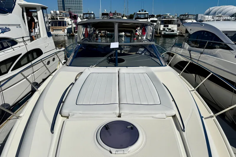 Slide: The Image of 2006 Azimut Atlantis 47 yacht docked at a marina, surrounded by other boats. - 2