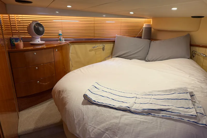 Slide: The Image of Luxurious cabin interior of 2006 Azimut Atlantis 47 yacht with cozy bed and wooden furnishings. - 31