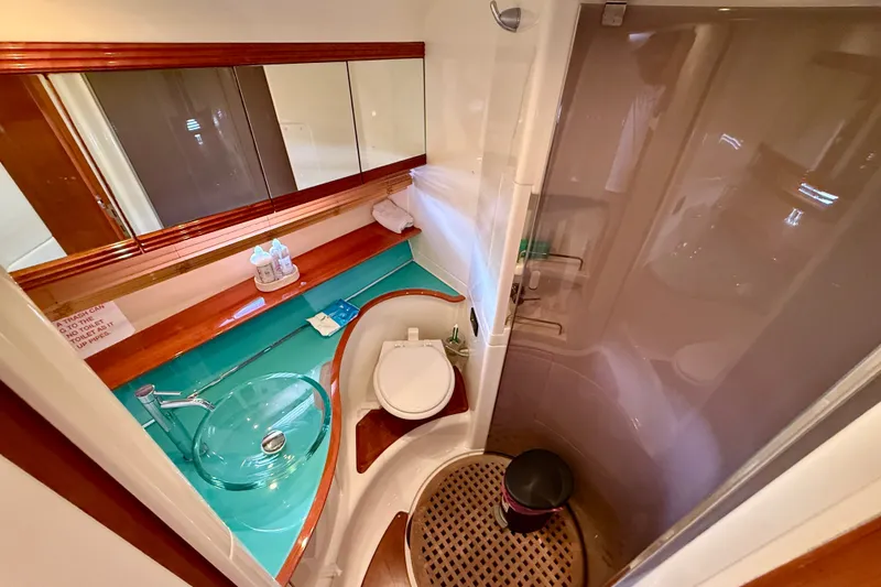 Slide: The Image of Luxurious bathroom in 2006 Azimut Atlantis 47 yacht with modern fixtures and glass sink. - 26