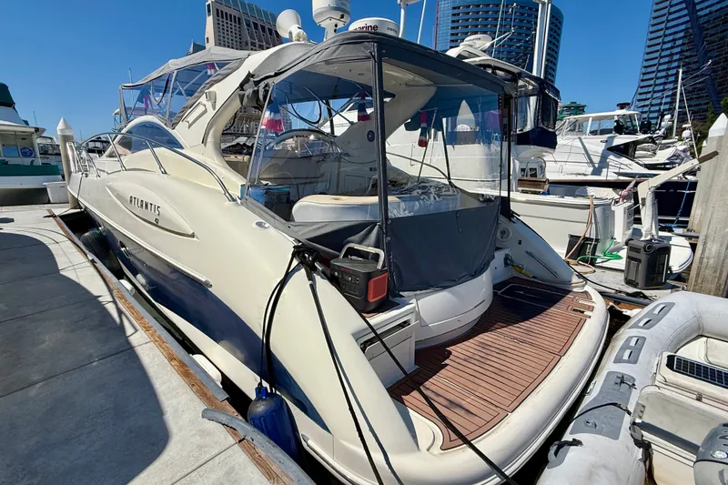 Slide: The Image of Azimut Atlantis 47 yacht, 2006 model, docked at a marina with clear blue skies. - 6