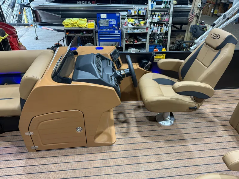 Slide: The Image of The image shows the cockpit of a Bentley Pontoons Legacy 220 Swingback with a Honda 4-Stroke EFI engine. It features a sleek, modern helm with a comfortable captain's chair and a well-equipped dashboard. - 10