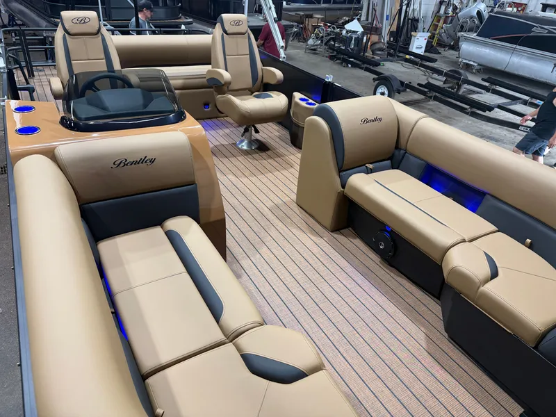 Slide: The Image of The image shows the interior of a Bentley Pontoons Legacy 220 Swingback with luxurious seating and blue lighting. - 30