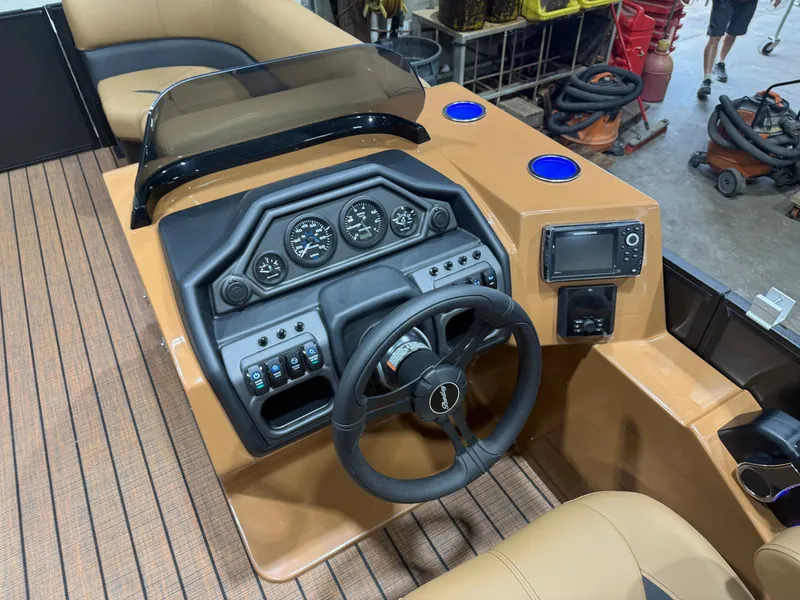 Slide: The Image of The image shows the cockpit of a Bentley Pontoons Legacy 220 Swingback with a modern helm. - 12