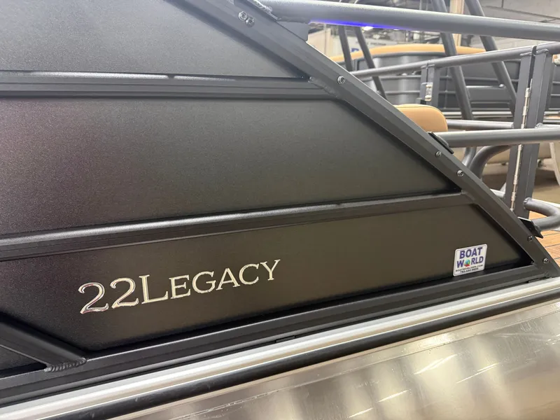 Slide: The Image of Close-up of Bentley Pontoons Legacy 220 Swingback with "22Legacy" lettering and "Boat World" logo. - 39