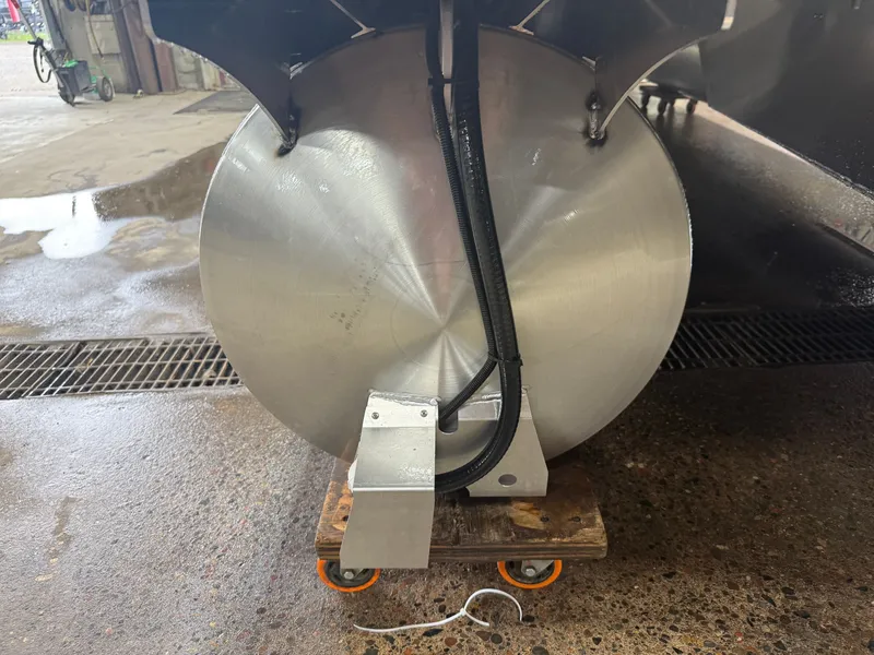 Slide: The Image of A pontoon boat with a round aluminum hull on a dolly in a workshop. - 41