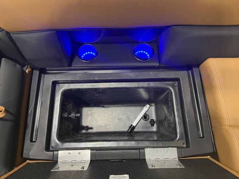 Slide: The Image of An open storage compartment with blue LED lighting and brown upholstery. - 29
