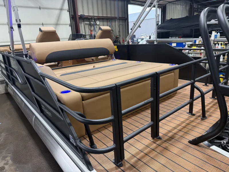 Slide: The Image of A Bentley Pontoons Legacy 220 Swingback with Honda 4-Stroke EFI. It features a beige lounge area and black railing. - 40