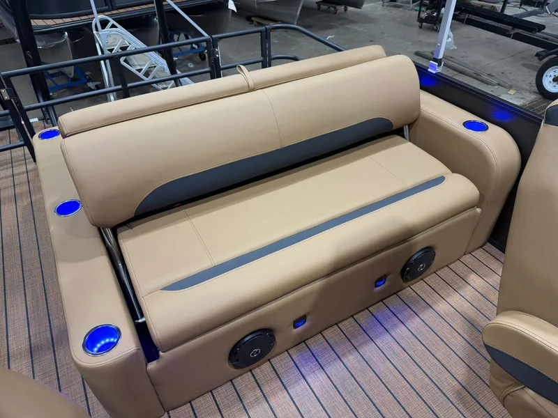Slide: The Image of The image shows a beige bench seat on a Bentley pontoon boat with blue cup holders. - 16