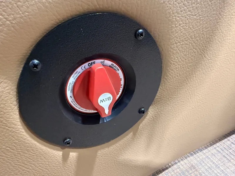 Slide: The Image of A red switch on a beige surface, surrounded by a black ring. - 24