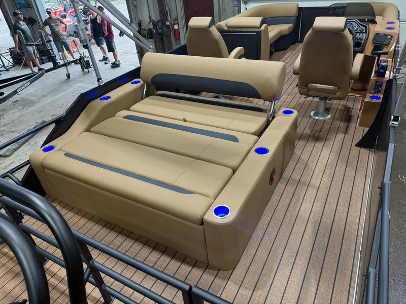 Slide: The Image of The image shows the interior of a Bentley Pontoons Legacy 220 Swingback with sleek beige seating. - 22