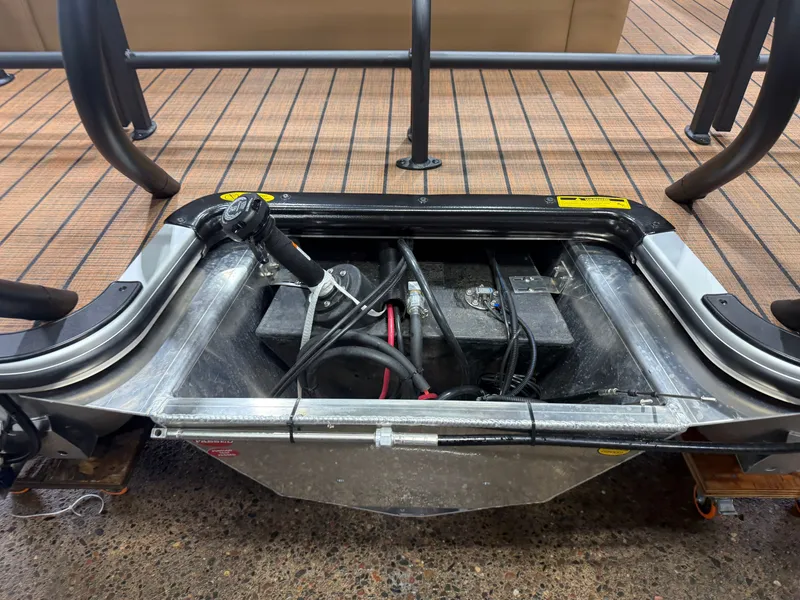 Slide: The Image of An open compartment on a pontoon boat reveals batteries and cables. The flooring is wooden. - 42