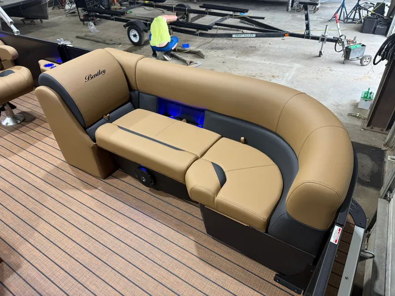 Slide: The Image of The image shows a luxurious seating area on a Bentley pontoon boat with elegant upholstery. - 8