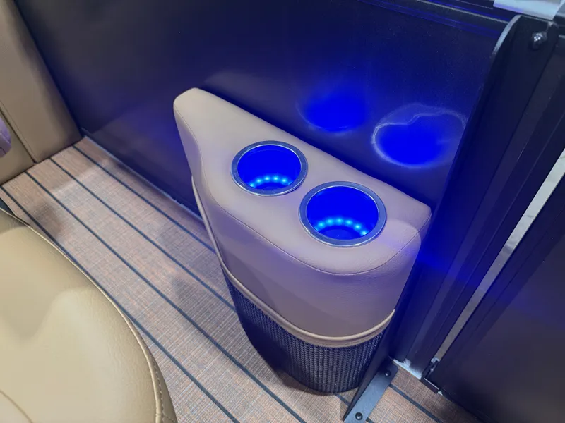 Slide: The Image of Illuminated cup holders on a boat with wood flooring and beige upholstery. - 25