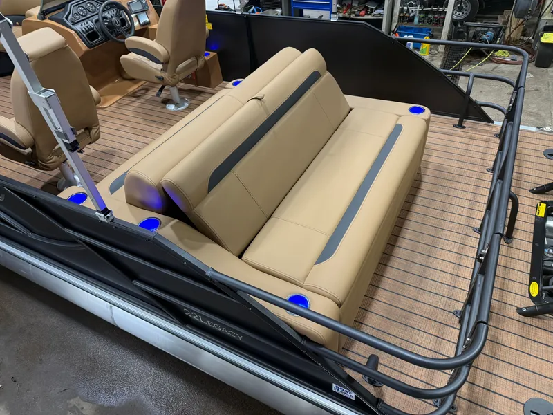 Slide: The Image of The image shows the interior of a Bentley Pontoons Legacy 220 Swingback with beige seats and blue lights. - 5