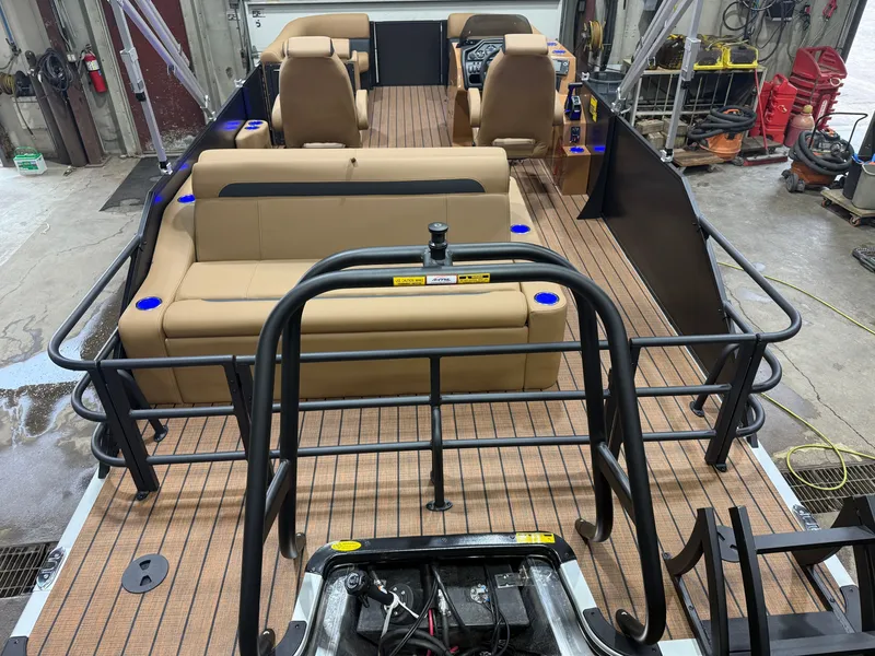 The Image of Interior view of a Bentley Pontoons Legacy 220 Swingback with beige seating and wood flooring. - 1