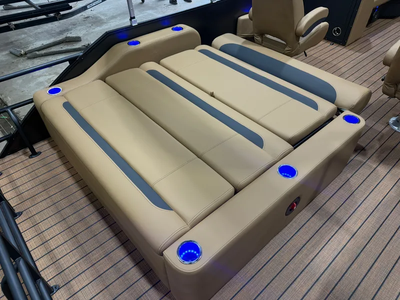 Slide: The Image of The image shows a luxurious lounge area on a Bentley pontoon boat with blue LED lighting. - 18
