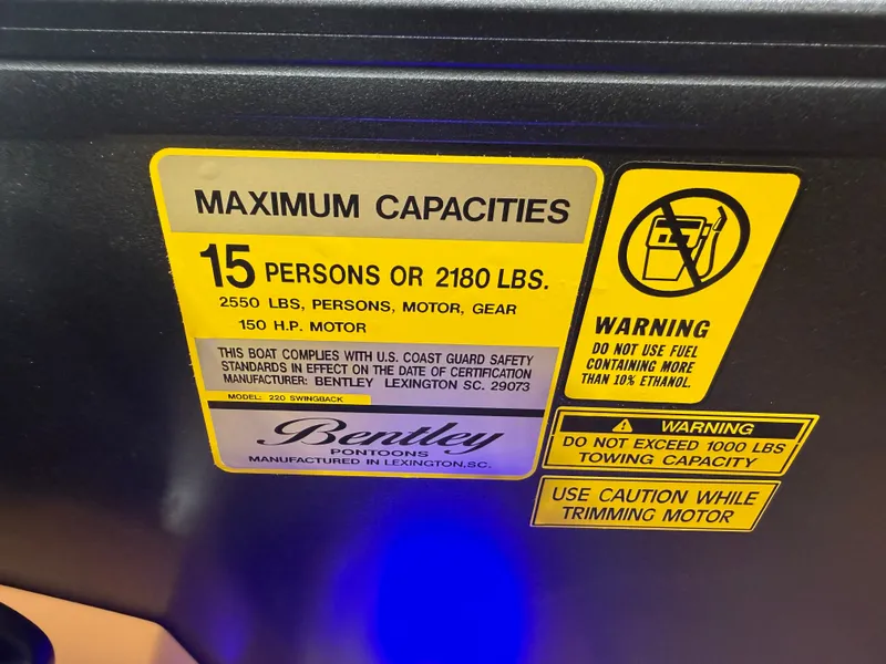 Slide: The Image of Sign showing maximum capacity: 15 persons or 2180 lbs. Includes fuel usage warnings. - 15