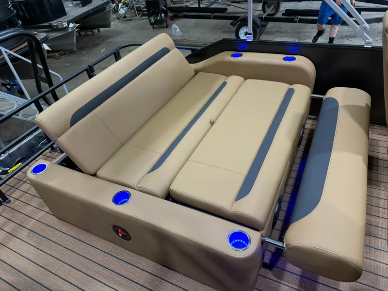 Slide: The Image of The image shows a luxurious beige lounge area on a pontoon boat with blue LED cup holders. - 19