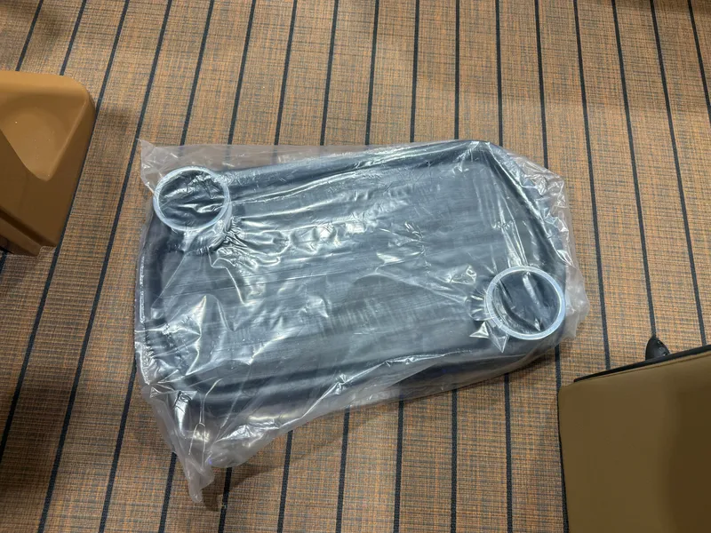 Slide: The Image of A plastic-wrapped table with two cup holders on a striped floor. - 32