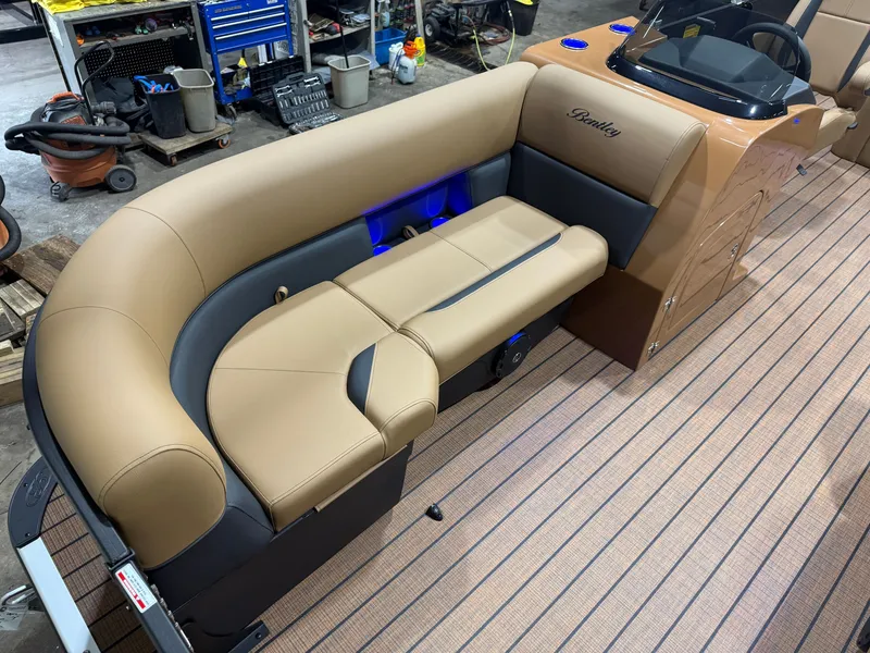 Slide: The Image of Luxurious seating area on a Bentley pontoon boat with sleek beige upholstery and blue lighting. - 7
